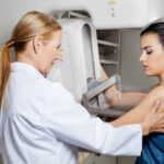 Mature,Female,Doctor,Assisting,Young,Patient,Undergoing,Mammogram